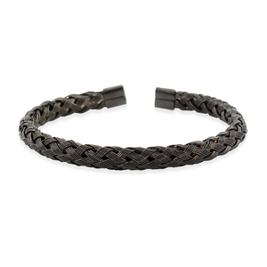 Detailed close-up of dark metallic twisted wire mesh bangle with open cuff design