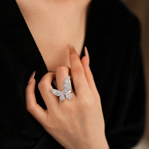 Detail of luxury zircon butterfly open ring showing intricate stone setting on hand