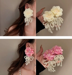 Detail of fabric flower earrings with tassel imitation pearls in cream and pink