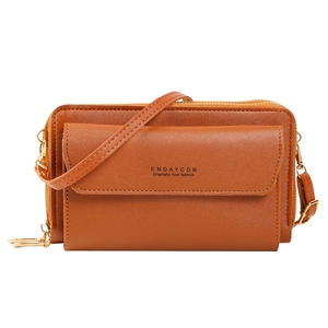 Cognac leather crossbody phone bag with double zippers and golden hardware on white background