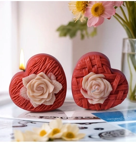 Detailed view of woven heart candle with rose relief texture and burning flame