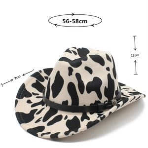 Detail view of cow print wool fedora featuring a black leather band and metal buckle