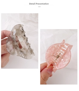 Detail view of large acetate claw clips in grey marble and pink shell textures