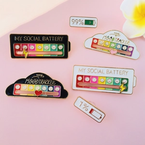 Macro detail of My Social Battery enamel pin showing sliding mood tracker on pink surface