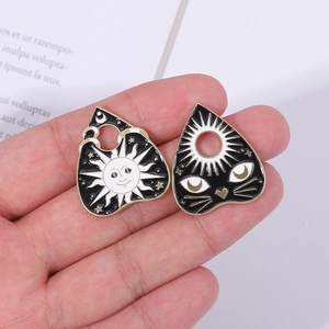 Gothic tarot style enamel pins featuring celestial sun and mystical cat head designs