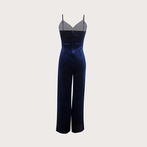 Detail of dark blue velvet jumpsuit with shimmering glitter and thin spaghetti straps