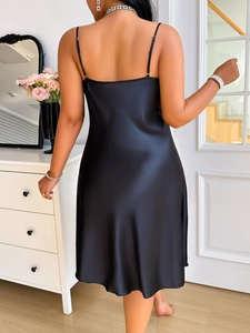Detail of black silk satin slip nightgown with adjustable straps and open back design