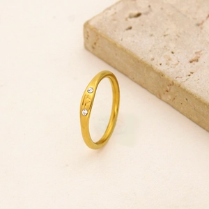 Detail of 18K gold stainless steel Libra ring with two sparkling side diamonds