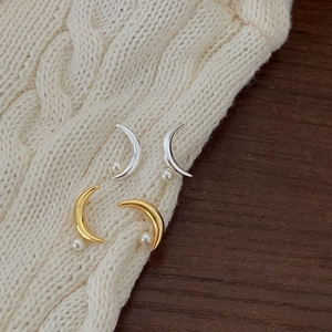 Elegant 925 sterling silver moon and pearl stud earrings on a cozy knit background
