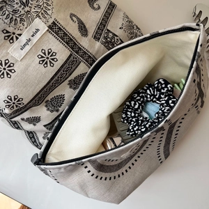Macro shot of paisley canvas makeup bag detail with zipper and fabric texture