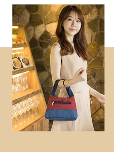 Close-up of contrast lunch bag with dual color canvas fabric and sturdy handle