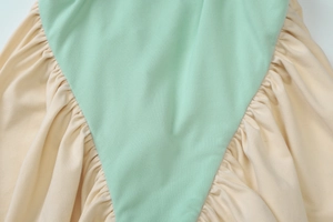 Close-up of contrast stitching detail on the sexy backless dress with soft fabric texture