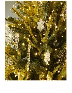 Close-up of clear acrylic crystal snowflakes and icicles hanging on a Christmas tree