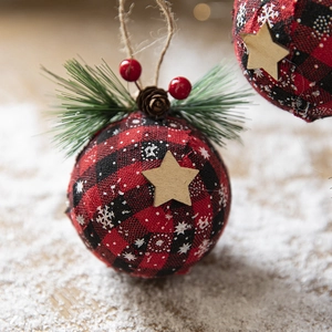 Christmas plaid fabric ball ornament with pine needles, cones and wooden star on twine