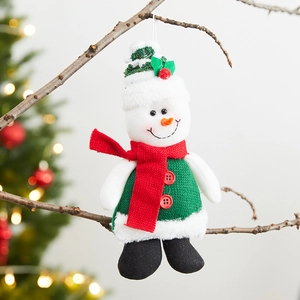 Plush snowman Christmas tree ornament with green knit sweater on a rustic branch