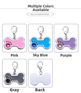 Detail view of bone-shaped zinc alloy pet ID tags with rhinestone paw prints in multiple colors