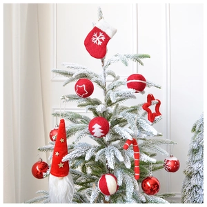 Detail of red and white wool felt Christmas ornaments with star and snowflake patterns