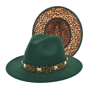 Detail of dark green fedora with leopard print brim and golden star-shaped metal buckles