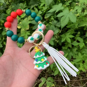 Christmas beaded keychain bracelet with silicone tree charm and long white tassel detail