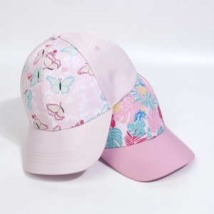 Detailed view of floral and tropical print baseball caps in light and peach pink shades