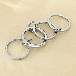 Macro detail of silver interlocking ring set featuring one band with pavé set crystals