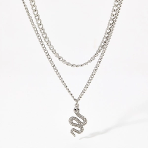 Macro detail of silver double-layer snake pendant necklace in polished stainless steel