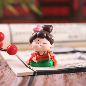 Macro detail of Tang Dynasty lady figurine in traditional attire on a classic book