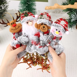 Close-up of four plush Christmas ornaments featuring Santa and reindeer with bells