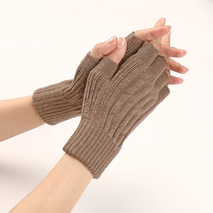 Detailed knit texture of brown fingerless gloves worn by a model on a white background