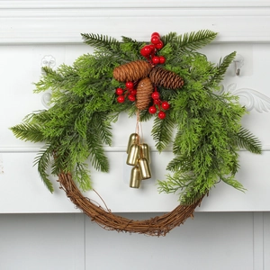 Detailed view of farmhouse Christmas wreath with green cedar, red berries and gold bells