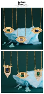 Detail view of gold necklaces with emerald and sapphire pendants on a dark green surface