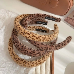 Three plush leopard print headbands with padded sponge design for a vintage winter style