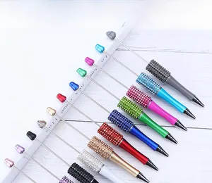 Detail showing various colors of DIY beaded pens with sparkling rhinestone barrels and metallic stems