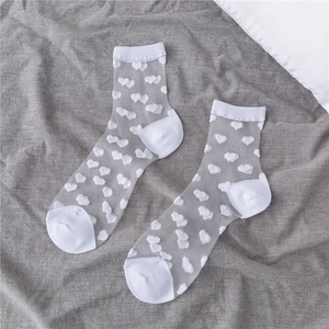 Detail of white sheer mesh socks with velvet heart pattern and reinforced toes