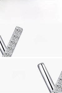 Macro detail of 925 sterling silver X-shape earrings with hand-set 5A cubic zirconia
