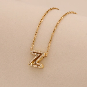 Macro detail of gold letter Z pendant with sparkling cubic zirconia on a delicate chain