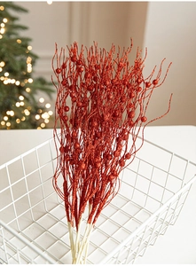 Close-up of sparkling red glitter floral picks in a white basket for Christmas decor