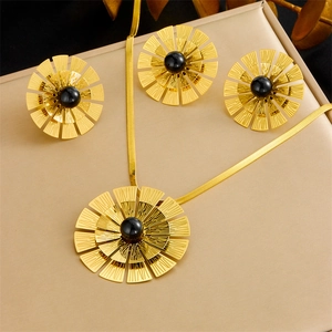 Golden sunflower jewelry set with black pearl inlay featuring necklace and earrings