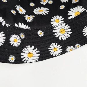 Black cotton bucket hat with white daisy print and quilted brim for sun protection
