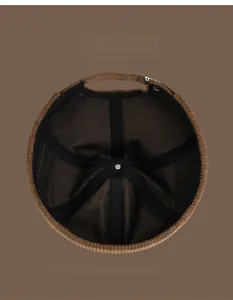 Detail of the brown docker hat interior showing black mesh lining and reinforced stitching