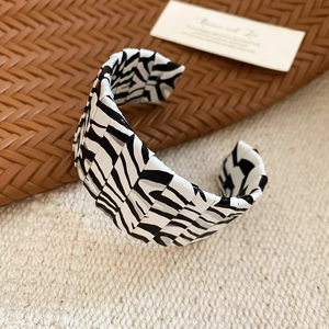 Detail shot of wide cuff bracelet featuring zebra print pattern and modular design