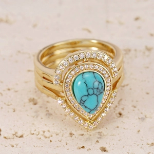 Detailed macro view of bohemian ring set with water-drop turquoise and pavé cubic zirconia