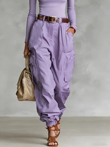 Detail of high waist purple cargo pants with pocket features and loose wide leg fit