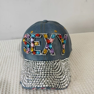 Detailed shot of dark blue denim cap with colorful crystal SEXY letters and silver rhinestones