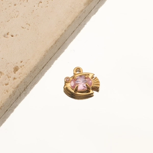 Detailed close-up of 18K gold-plated fish pendant with pink oval gemstone and crystal eye