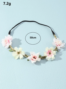 Detail view of handmade floral headband with size 50cm and weight 7.2g on blue background