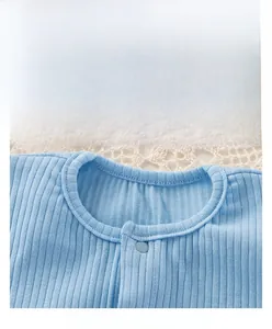 Detail of light blue baby bodysuit neckline with breathable ribbed fabric and snap button