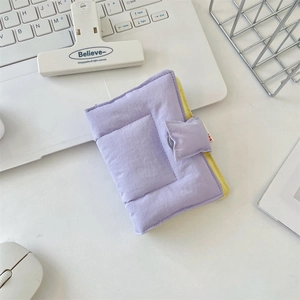 Macro view of purple quilted fabric notebook cover with yellow contrasting lining details