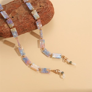 Colorful resin glasses chain on natural wood with gold clasps and silicone loops