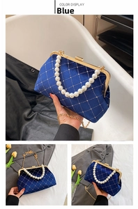 Detail of blue velvet shell bag with pearl handle and silver diamond quilted pattern